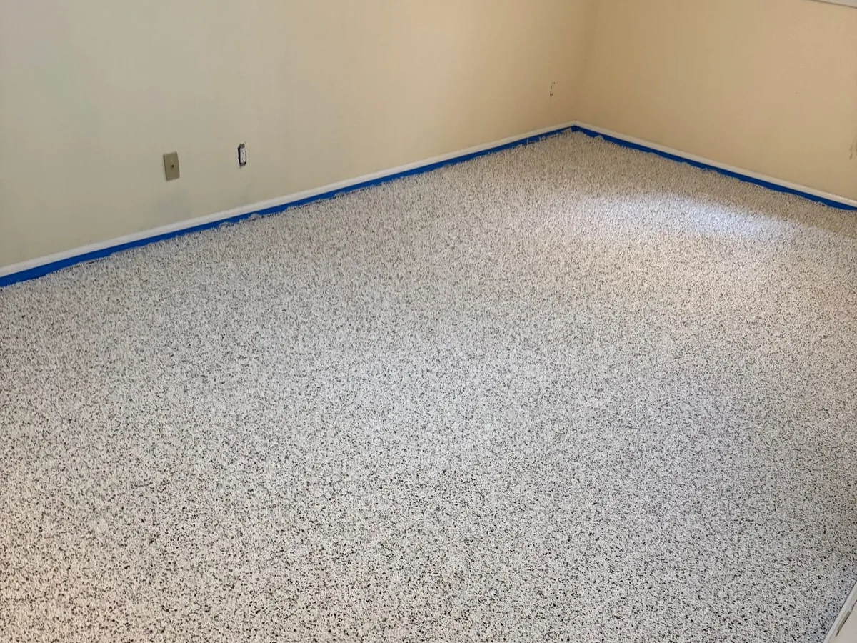 Light flake basement floor coating in a finished basement room