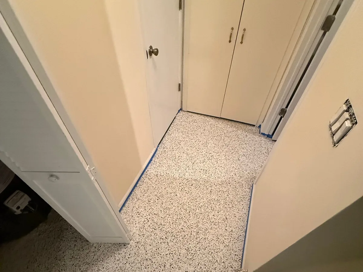 Light flake floor coating in a basement hallway