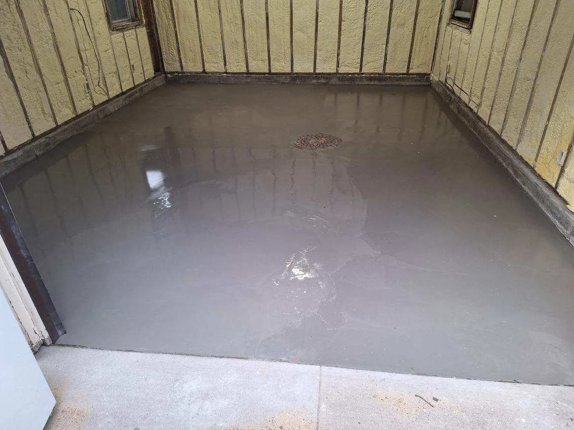 Freshly poured self leveling overlay resurfacing a concrete floor