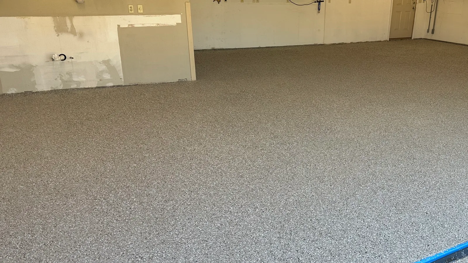 Tan and gray flake garage floor coating in a large attached garage