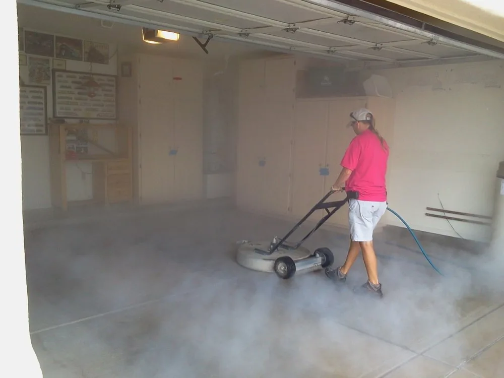 Rotary surface cleaner washing a garage floor