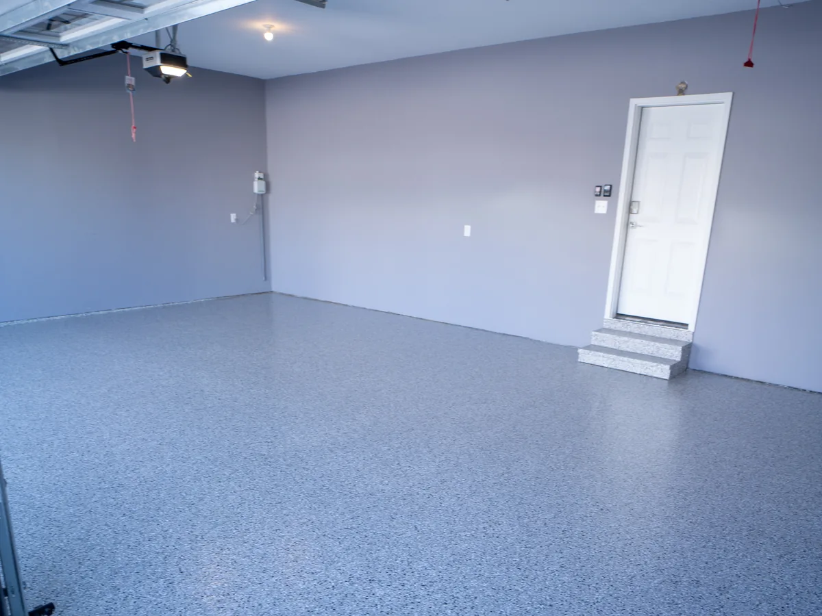 The same garage with a finished blue and gray flake floor coating