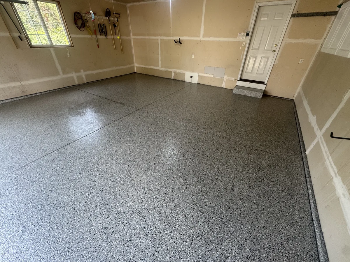 The same garage with a glossy gray flake floor coating