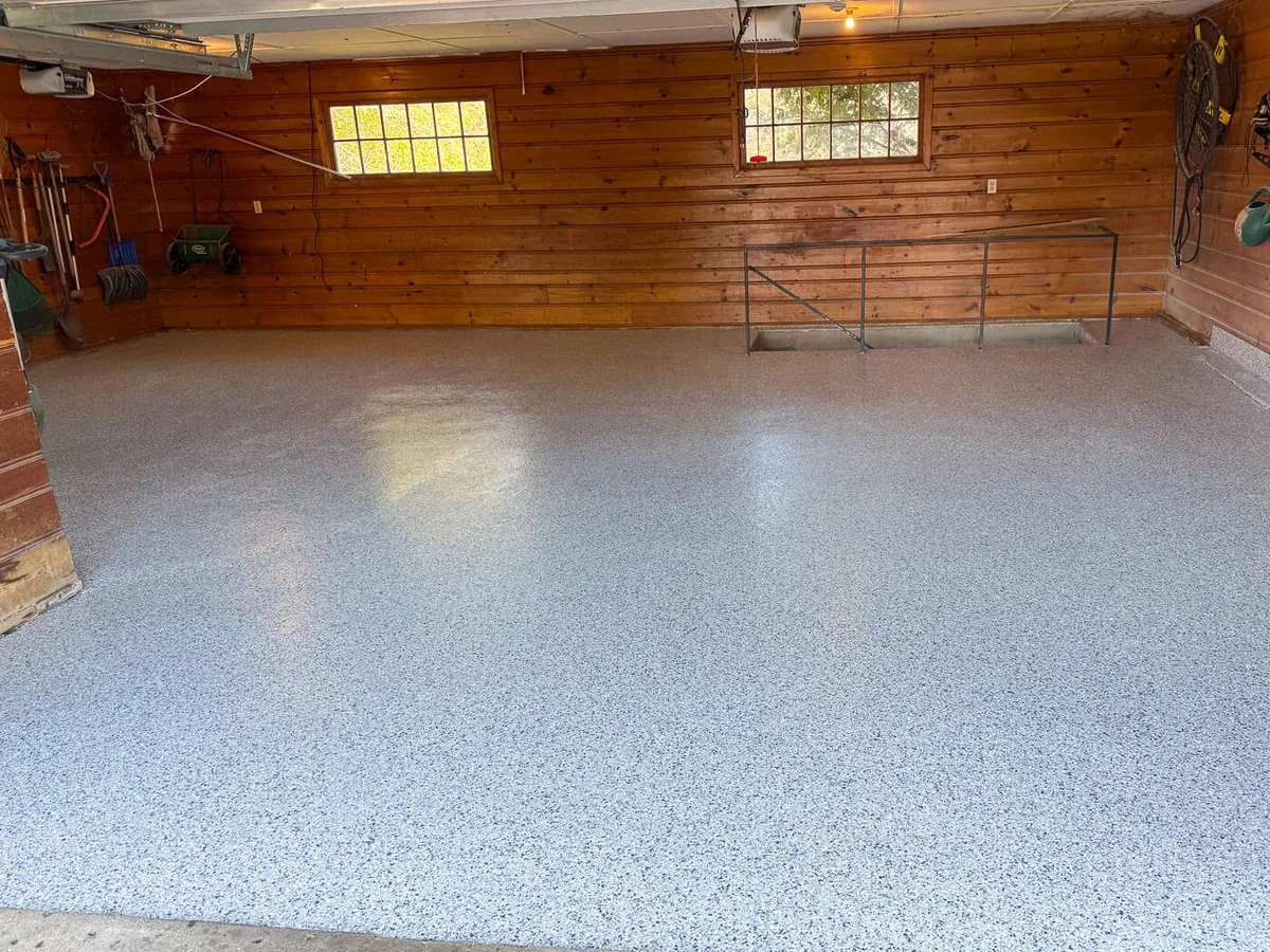 Tidal Wave flake garage floor coating in a wood paneled garage