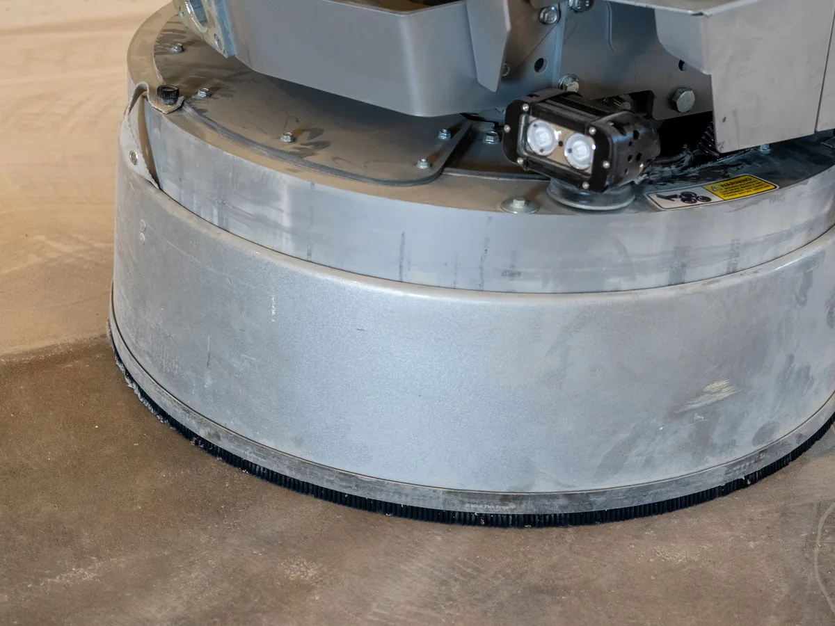 Diamond grinder working on a bare concrete slab