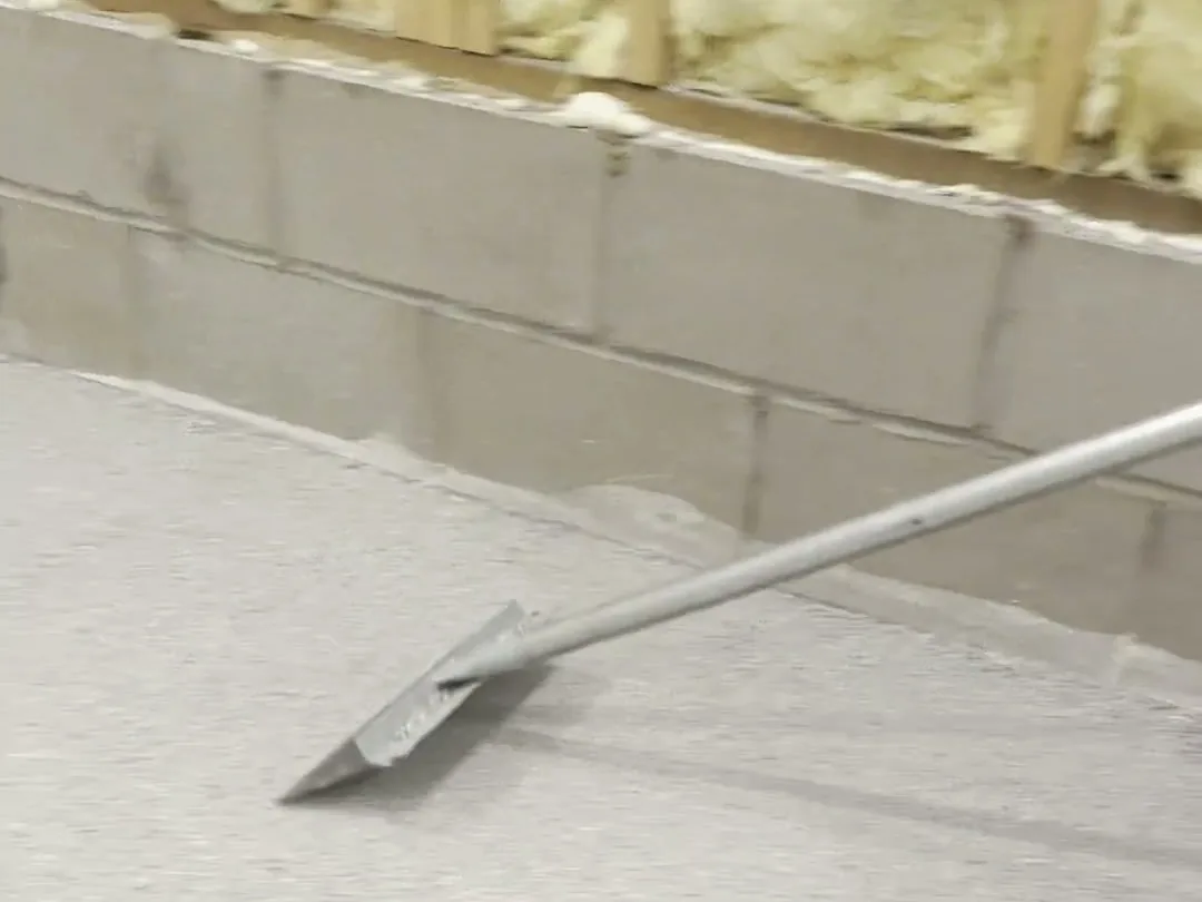 Scraping loose flake off a fully broadcast floor