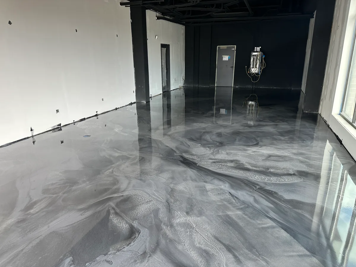 Gray and white metallic epoxy floor in an empty commercial space