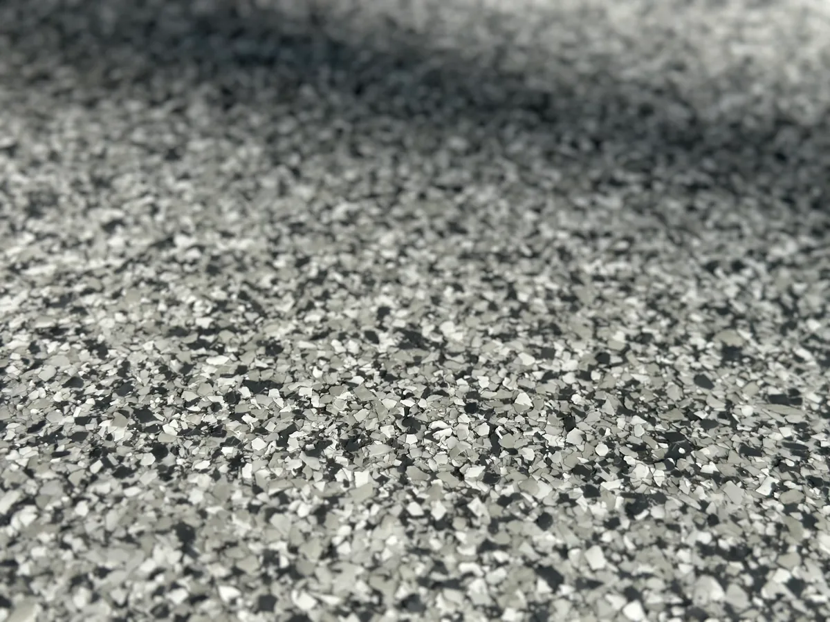 Close up of a full broadcast flake floor with a glossy clear topcoat