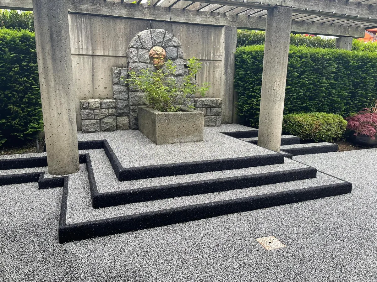Rubber surfaced patio steps with black rubber edging under a pergola